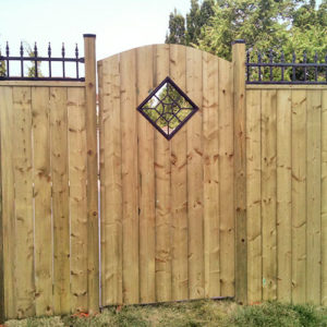 Wooden fencing with gate and wrought iron trim