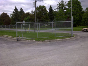 Security chain link fencing with large entrance gate