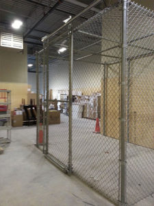 Chain link safety enclosure inside a warehouse