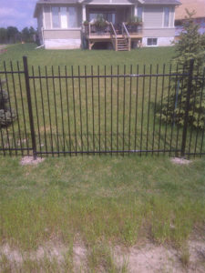 Residential wrought iron fencing along front of property